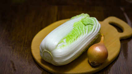 Fresh Napa cabbage isolated on a wooden board