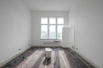 empty  room during renovation with paint bucket