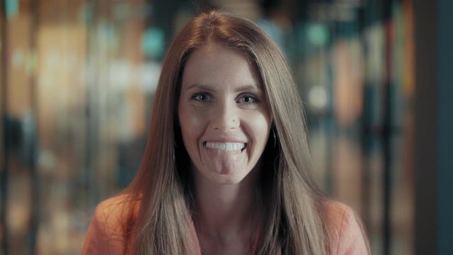 Woman smiling and showing tongue.