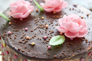 Homemade chocolate cake decorated with edible roses and leaves