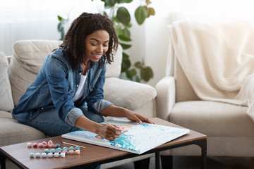 Painting By Numbers. Happy Black Woman Drawing Canvas Picture At Home - Powered by Adobe