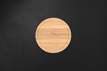 Round wooden tray or cutting board on table. Top view