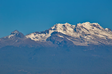 Iztaccihuatl snowy volcano with blue sky