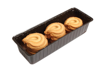 Butter cookies in disposable plastic packing box. Isolated with clipping path.