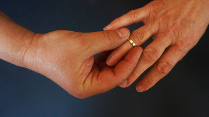 Hands putting on rings love elderly people