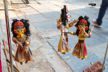 Traditional nepalese God Ganesha puppets hangs on strings by souvenir shop on the street of...