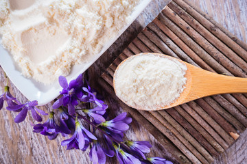 Bowl with hydrolyzed collagen, on rustic wooden background, top view