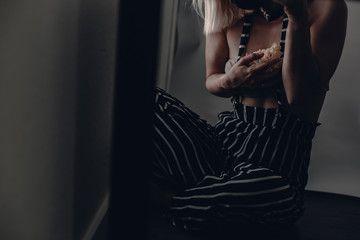 Woman in striped pants sits near window. Self portrait. Mirror reflection. Moody woman photography. Artistic concept. Blonde lady. Sensual, tender, innocence. Square mirror. Black frame. Camera