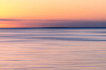 Fototapeta na wymiar colorful sunset over the sea with orange sky. Abstract