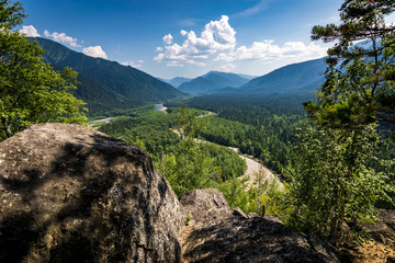 Mountain Cap of Monomakh summer in the snowy river valley