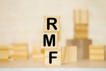 Wood block word RMF and coins with copy space using as background business financial, saving money, retirement concept.