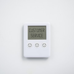 Customer service satisfaction concept with digital clock with different expressions of satisfaction printed on the buttons