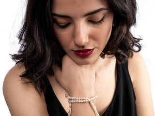 woman with pearl diamond necklace in hand