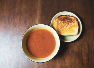 Bowl of tomato soup with a grilled cheese sandwich