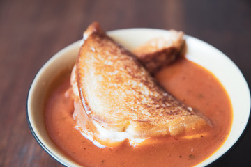 Bowl of tomato soup with a grilled cheese sandwich