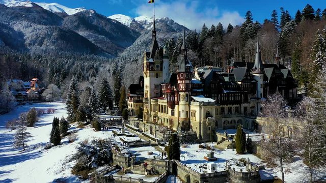 Aerial drone view of a beautiful Peles castle in Sinaia in the winter season, Transylvania, Romania