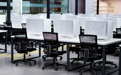 Photo of a computers wrapped in cover, empty coworking