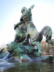 statue in hamburg park germany Stuhlmannbrunnen Sunny day Man fishing