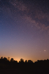 Naklejka na ściany i meble Landscape with blue Milky Way. Night sky with stars. Beautiful milky way taken in Ukraine during a clear night