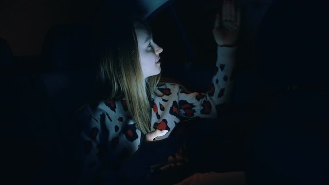 Young Woman In The Backseat Of A Car At Night