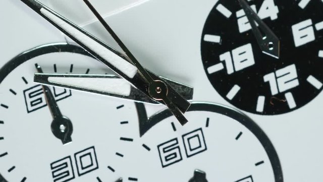 Macro shot of clock face with rapid rotation of all body and almost static seconds arrow. Fast flow of time concept. Real watch shot with wide macro lens close-up view. 4k.