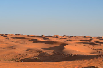 Fototapeta na wymiar Off-road safari trip at the dunes in the red sand desert in Saudi Arabia. Arabic people making picnics in the desert far away from the city.