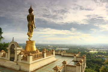 Golden Buddha standing on a mountain Wat Phra That Khao Noi, Nan province Thailand 