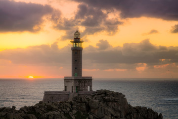 Punta Nariga Lighthouse at sunset in Malpica, Galicia, Spain