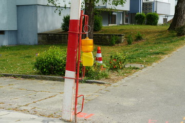 vertical barrier planks in red and white with warning orange and yellow light  as well as...