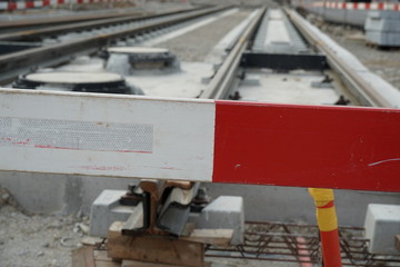 constructing of street-car line, embedding of metal rails in a concrete base with a barrier planks in the foreground for security reasons