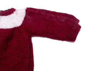 A warm knitted dark red or wine coloured sweater with white stripe. Kid's clothes and apparel isolated on white.