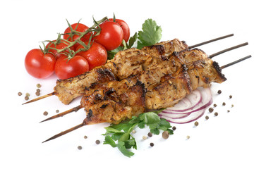pork kebab with tomatoes and spices isolated on a white background