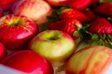 Close Up of Fresh Organic Strawberries and Apples in Water
