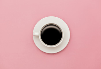 Obraz na płótnie Canvas White cup of coffee on pink background