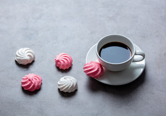 meringue and cup of coffee on gray