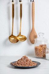 boiled buckwheat on a plate, vegetarian dish