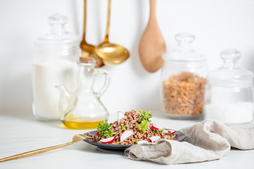 boiled buckwheat with parsley and fork on a plate