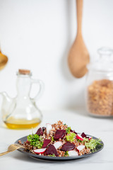 boiled buckwheat with radish and beetroot  on a plate, vegetarian dish