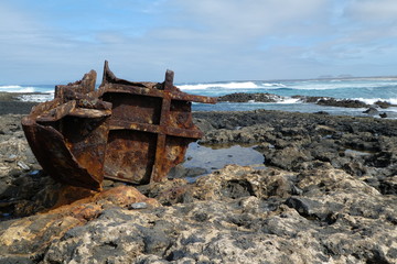 rusty iron work on a rock beach near the sea spain