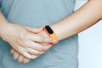 Woman using  fitness tracker on her hand.