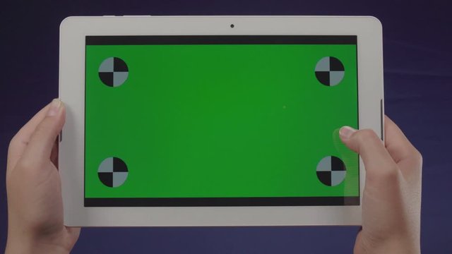 Woman using a tablet with green screen &ndash; Chroma Key