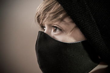 portrait of a young boy with a mask, child with mouth covering, prevention mask, to avoid covid-19 diseases. looking at camera
