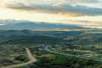 And interstate highway weaving through the wilderness of Arizona in early morning light.