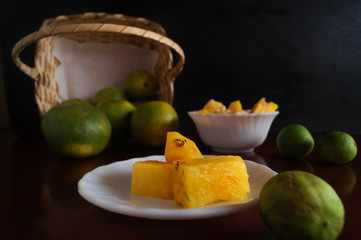 pineapple and oranges fallen from the basket