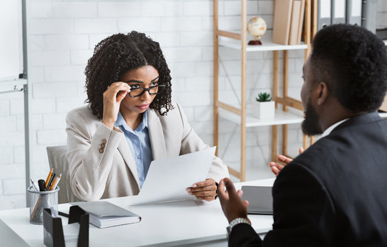 Human resources manager with African American candidate on job interview in office. Panorama