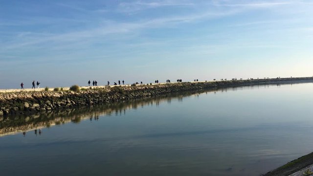 People walking on a beautiful sunny day at Parque das Nacoes or Park of Nations, former Expo98 in Lisbon.
