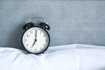 Alarm clock on grey background with copy space for you design..