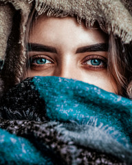 Closeup portrait of a girl in a headscarf with blue eyes