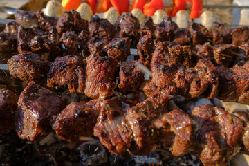 a lot of meat is fried on the fire