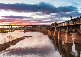 Cloudy Sunset over James River, Browns Island, Richmond Virginia. Old Rusty Train Track over the...